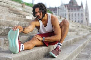 man on stairs demonstrating how to stretch